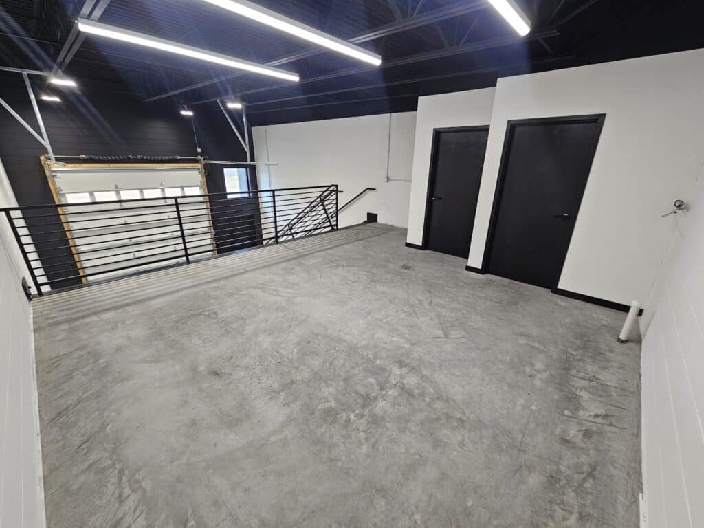 Mezzanine and entry doors in a Hide Out garage suite before any owner build-out